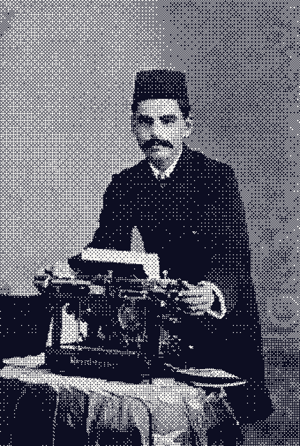 A young man in a fez stands behind a Remington typewriter, his hands on the keys.